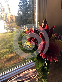 Mixed bouquet of flowers in a window