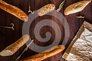 Mixed breads background on wooden table, top view for your text.