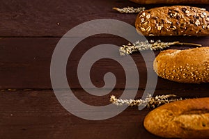 Mixed breads background on wooden table, top view for your text.