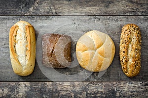 Mixed breads on wooden table.