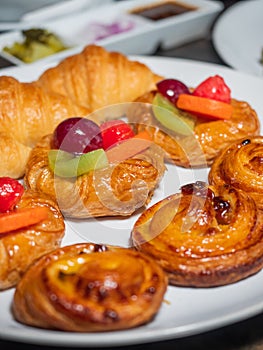 Mixed breakfast pastries serving on the white plate