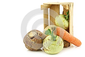 Mixed cabbage and root vegetables in a wooden crate