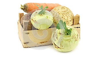 Mixed cabbage and root vegetables in a wooden crate