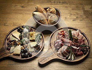 Mixed charcuterie and cheese cold cuts platter on wood table