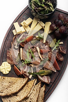 Mixed cheese and cold cuts board on white background