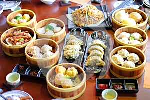 Mixed chinese steamed dumpling dim sum, crab stick, ha gow, seaweed, coriander, noodle, gyoza and garlic for background or