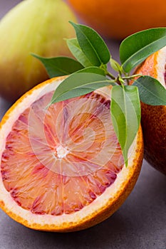 Mixed citrus fruit figs, limes on a gray background.