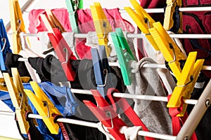 Mixed clean laundry pinned with colourful clothespins