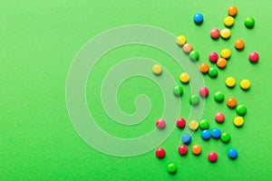 Mixed collection of colorful candy, on colored background. Flat lay, top view. frame of colorful chocolate coated candy