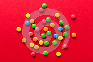 Mixed collection of colorful candy, on colored background. Flat lay, top view. frame of colorful chocolate coated candy