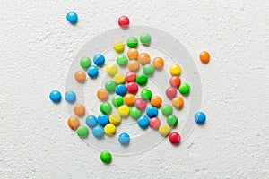 Mixed collection of colorful candy, on colored background. Flat lay, top view. frame of colorful chocolate coated candy