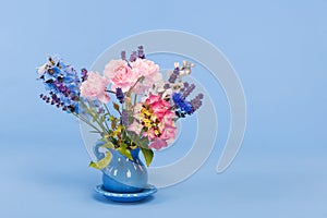 Mixed colorful bouquet on blue background