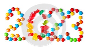 Mixed colorful candies. New year 2023 made of color sweets on white background.