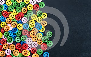Mixed coloured bright buttons on a black background