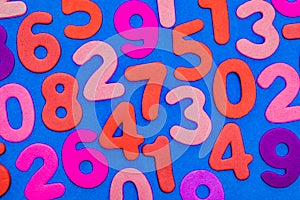 Mixed coloured numbers on a blue background.