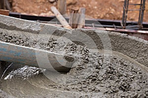 Mixed concrete pouring at construction site