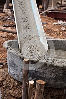 Mixed concrete pouring at construction site