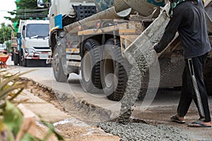 Mixed concrete pouring at construction site. Pouring cement during sidewalk upgrade.