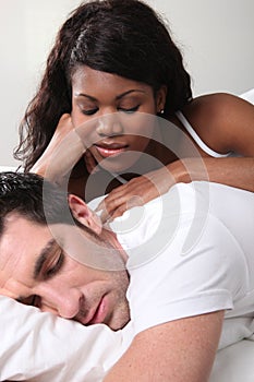 Mixed couple in bed