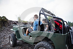 Mixed couple riding a jeep off road