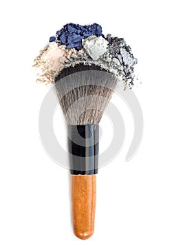 Mixed crushed make up eyeshadow with brush. Isolate on white