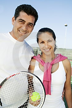 Mixed doubles Tennis Players standing on tennis court portrait