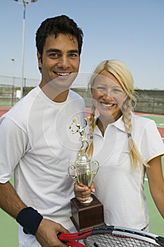 Mixed doubles Tennis Players on tennis court holding trophy portrait