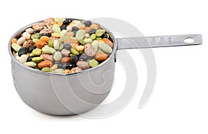 Mixed dried beans in a metal cup measure