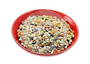 Mixed dried beans and peas in a red bowl