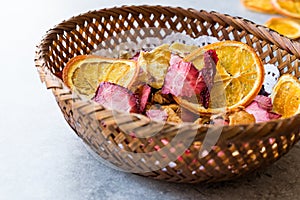 Mixed Dried Fruits Orange, Strawberry, Pineapple, Cherry and Apple Slices with Cinnamon Powder in Wooden Basket