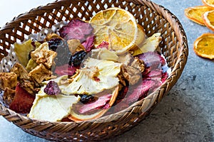 Mixed Dried Fruits Orange, Strawberry, Pineapple, Cherry and Apple Slices with Cinnamon Powder in Wooden Basket