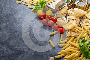 Mixed dried pasta selection on wooden background. composition of healthy food ingredients