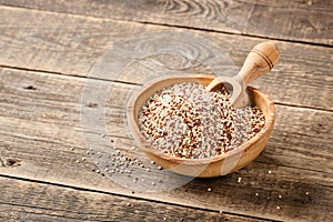 Mixed dry quinoa in wooden bowl