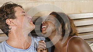 Mixed ethnicity couple in love cuddling together at home in bed with beautiful playful black afro American girlfriend or wife and