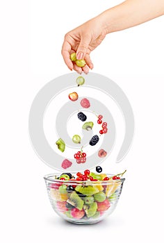 Mixed falling berries and fruits in bowl
