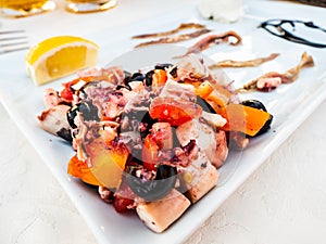 Mixed fish salad, with octopus, tomatoes and olives