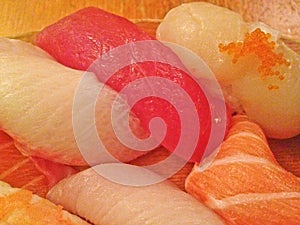 Mixed fresh Japanese sushi platter served on wooden plate