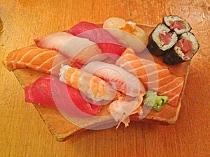 Mixed fresh Japanese sushi platter served on wooden plate