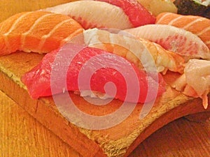 Mixed fresh Japanese sushi platter served on wooden plate