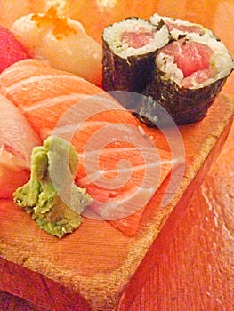 Mixed fresh Japanese sushi platter served on wooden plate