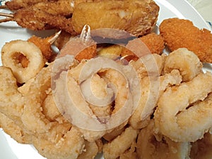mixed fried fish with squid rings, crab claws, battered cod and fish skewers