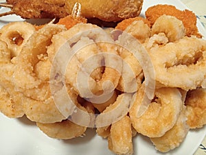 mixed fried fish with squid rings, crab claws, battered cod and fish skewers