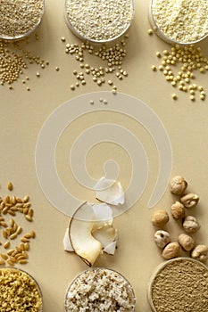 Mixed, gluten-free flour set on beige background with cereals, seeds and nuts