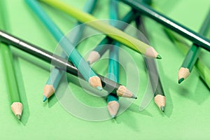 Mixed Green colored pencils on green table