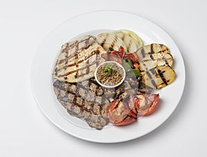 Mixed Grill of Chicken Breast and Beef served with tomatoes, mushroom and pepper