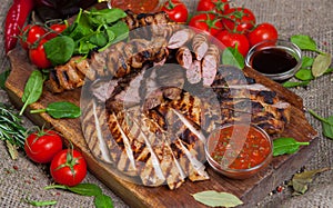 Mixed grilled meat platter. Assorted delicious grilled meat with vegetable.