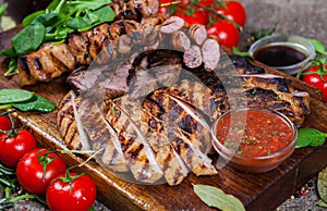 Mixed grilled meat platter. Assorted delicious grilled meat with vegetable.