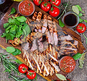 Mixed grilled meat platter. Assorted delicious grilled meat with vegetable.