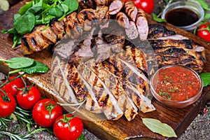 Mixed grilled meat platter. Assorted delicious grilled meat with vegetable.