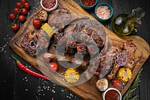 Mixed grilled meat platter on a black background